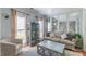 Bright living room with large windows, hardwood floors, and neutral-toned furniture at 12112 Autumn Winds Ln, Pineville, NC 28134