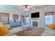 Cozy living room with fireplace, comfortable seating, and plenty of natural light at 12112 Autumn Winds Ln, Pineville, NC 28134