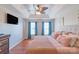 Comfortable main bedroom featuring hardwood floors, a ceiling fan, and natural light at 12112 Autumn Winds Ln, Pineville, NC 28134
