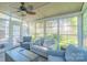Relaxing sunroom featuring comfortable seating, a ceiling fan, and lots of windows at 12112 Autumn Winds Ln, Pineville, NC 28134