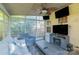Cozy sunroom with comfortable seating and multiple windows offering scenic views at 12112 Autumn Winds Ln, Pineville, NC 28134