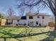 Spacious backyard featuring a two-story home, deck with outdoor seating, and green grass at 1225 Braeburn Rd, Charlotte, NC 28211