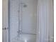 Bathroom featuring a white tiled shower and bathtub with chrome fixtures at 1225 Braeburn Rd, Charlotte, NC 28211