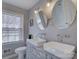 Bathroom with double sinks, stylish lighting, mirrors, and a window providing natural light at 1225 Braeburn Rd, Charlotte, NC 28211
