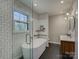 Bright bathroom featuring a modern soaking tub, subway tile walls and a window to view the outdoors at 1225 Braeburn Rd, Charlotte, NC 28211