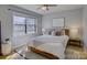 Comfortable bedroom with a queen-sized bed, nightstands with lamps, and natural light from a window at 1225 Braeburn Rd, Charlotte, NC 28211