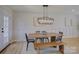 Dining room featuring modern lighting, table with bench seating, and neutral decor at 1225 Braeburn Rd, Charlotte, NC 28211