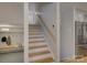 Hallway featuring a staircase, built-in bench with storage, and stainless steel refrigerator at 1225 Braeburn Rd, Charlotte, NC 28211