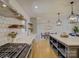 Modern kitchen featuring stainless appliances, subway tile backsplash, floating shelves and open floorplan at 1225 Braeburn Rd, Charlotte, NC 28211