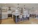 Bright kitchen featuring a large island with seating, modern appliances, and open layout to the dining area at 1225 Braeburn Rd, Charlotte, NC 28211