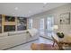 Living room featuring a sectional sofa, neutral walls, and a walkout to the patio at 1225 Braeburn Rd, Charlotte, NC 28211