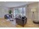 Sunlit living room with large window, hardwood floors, comfortable seating and stylish decor at 1225 Braeburn Rd, Charlotte, NC 28211