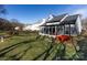 A well-maintained backyard with lush green grass and sunroom at 13807 Queenswater Ln, Charlotte, NC 28273