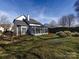 Spacious backyard featuring a sunroom, wooden fence, and lush green grass at 13807 Queenswater Ln, Charlotte, NC 28273