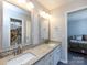 Bathroom with double sinks, granite countertop, framed mirrors, and view to Primary bedroom at 13807 Queenswater Ln, Charlotte, NC 28273
