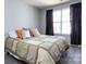 Bright bedroom with large window, dark curtains, and comfortable bed at 13807 Queenswater Ln, Charlotte, NC 28273