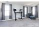 Bonus room with carpeted floors, three windows, two desks, and comfortable sitting area at 13807 Queenswater Ln, Charlotte, NC 28273