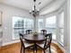Cozy breakfast nook with large windows, wood floors, and a chandelier at 13807 Queenswater Ln, Charlotte, NC 28273