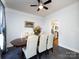 This dining room features a modern ceiling fan, elegant table set, and a view into the adjacent kitchen at 13807 Queenswater Ln, Charlotte, NC 28273