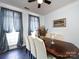 Elegant dining room with hardwood floors, large window with drapes, and decorative centerpieces at 13807 Queenswater Ln, Charlotte, NC 28273