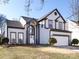 Charming two-story home with manicured lawn, arched entryway, two car garage, and gray and white trim at 13807 Queenswater Ln, Charlotte, NC 28273