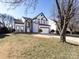 Charming two-story home with manicured lawn, arched entryway, two car garage, and gray and white trim at 13807 Queenswater Ln, Charlotte, NC 28273
