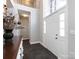 Elegant foyer with high ceilings, dark floors, staircase, chandelier, and a beautiful wooden console table at 13807 Queenswater Ln, Charlotte, NC 28273