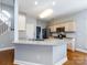 Well-lit kitchen with granite countertops, stainless steel appliances, and a breakfast bar for casual dining at 13807 Queenswater Ln, Charlotte, NC 28273