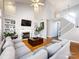 Bright living room with fireplace and a view of the staircase leading to the upper level at 13807 Queenswater Ln, Charlotte, NC 28273
