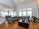 Open-concept living room with high ceilings, lots of natural light, and a seamless flow to the dining area at 13807 Queenswater Ln, Charlotte, NC 28273