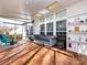 Sunroom featuring tile floors, built-in shelving and natural light at 13807 Queenswater Ln, Charlotte, NC 28273