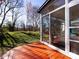 Spacious sunroom with a wooden deck and backyard lawn at 13807 Queenswater Ln, Charlotte, NC 28273
