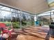 Large sunroom with tiled floor, many windows, and access to backyard at 13807 Queenswater Ln, Charlotte, NC 28273