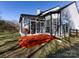 Sunroom and spacious backyard with a wooden deck and grey-painted house siding at 13807 Queenswater Ln, Charlotte, NC 28273