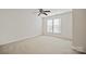 Empty bedroom with neutral carpet, ceiling fan and bright windows at 140 N Arcadian Way, Mooresville, NC 28117