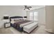 Stylish bedroom features a tufted headboard bed, bench and ceiling fan at 140 N Arcadian Way, Mooresville, NC 28117