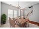 Dining room with a modern chandelier, natural light, and stairway access create an inviting space at 140 N Arcadian Way, Mooresville, NC 28117
