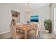 Dining room boasts a wooden table, seating for six, and natural light, creating a warm atmosphere at 140 N Arcadian Way, Mooresville, NC 28117