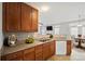 Kitchen with stainless steel appliances, countertop, and view into adjacent living and dining rooms at 140 N Arcadian Way, Mooresville, NC 28117