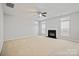 Bright living room features a fireplace, a ceiling fan, and windows to let in natural light at 140 N Arcadian Way, Mooresville, NC 28117