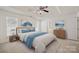 Bright main bedroom featuring a tray ceiling, fan, and an ensuite bathroom entrance at 140 N Arcadian Way, Mooresville, NC 28117