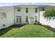 Private backyard with a well-kept lawn, patio area, white fence, and mature landscaping at 140 N Arcadian Way, Mooresville, NC 28117