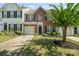 Traditional brick townhome with an attached garage, manicured landscaping, and a welcoming entrance at 140 N Arcadian Way, Mooresville, NC 28117