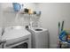 Functional laundry room with white washer and dryer and storage shelves for convenience at 140 N Arcadian Way, Mooresville, NC 28117
