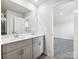 Bathroom with double sink vanity, a large mirror, and tile flooring at 1411 Windy Park Dr, Stanley, NC 28164