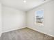 Bright bedroom with a window, neutral walls, and carpeted flooring at 1411 Windy Park Dr, Stanley, NC 28164