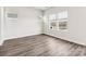 Bright and airy bedroom with three large windows and modern gray flooring at 1411 Windy Park Dr, Stanley, NC 28164