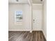 Bright entryway features wood-look floors, a window, and a white front door framed with white trim at 1411 Windy Park Dr, Stanley, NC 28164