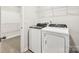 Functional laundry room features a side-by-side washer and dryer and wire shelving for ample storage at 1411 Windy Park Dr, Stanley, NC 28164