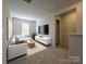 Living room with neutral walls, carpeted flooring, and a window at 1411 Windy Park Dr, Stanley, NC 28164